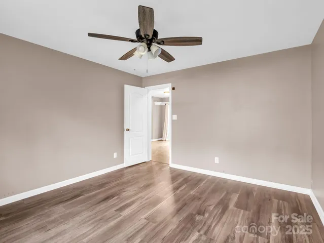 a view of an empty room and wooden floor