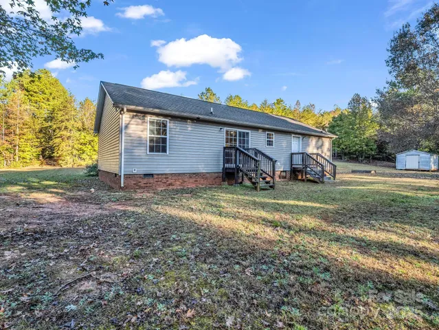 a view of house with backyard