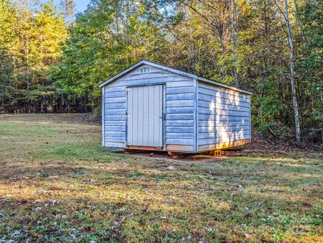 a view of backyard of house with green space