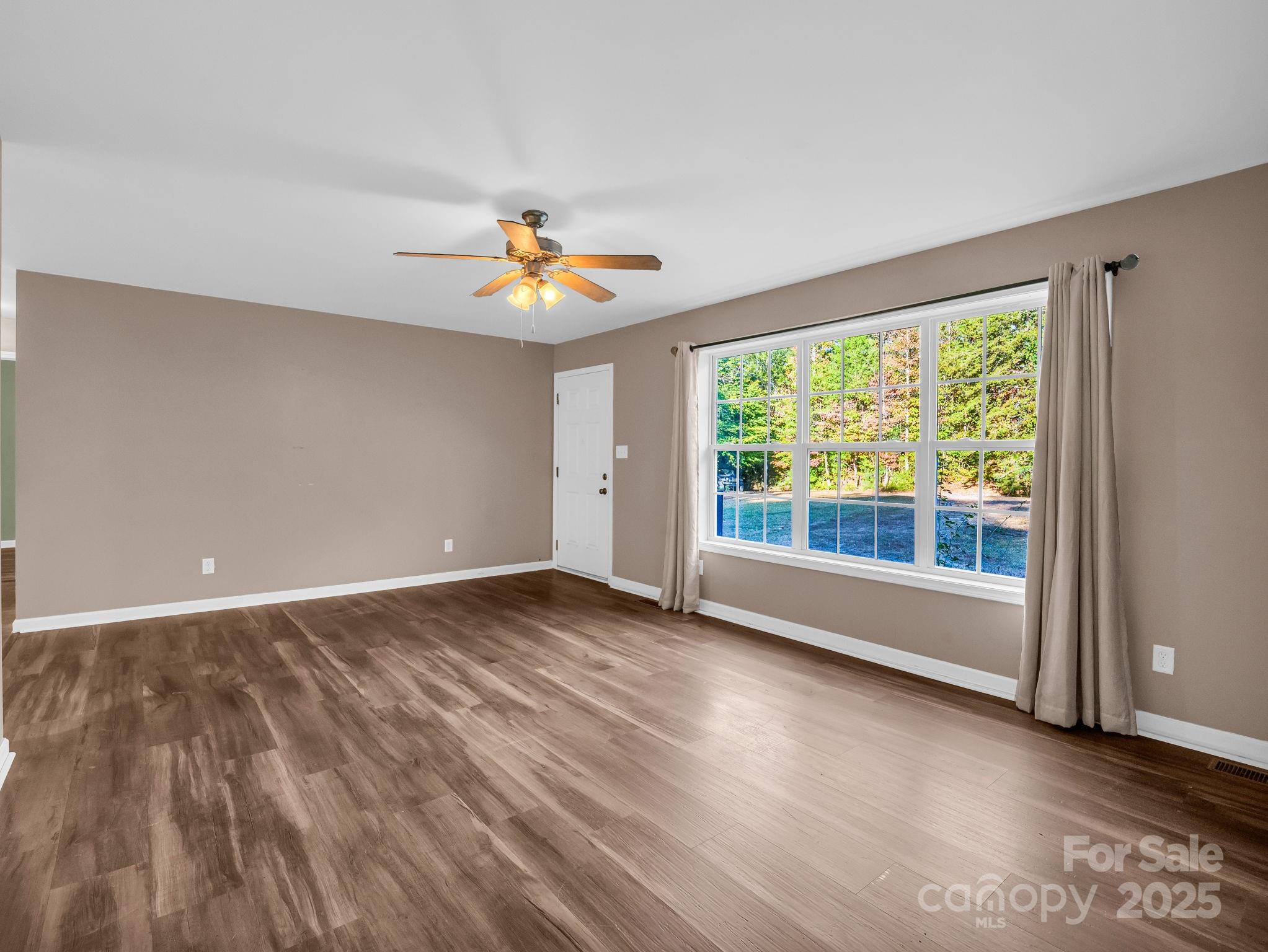 663 Landrum Road Columbus, NC 28722 - Photo 37 of 40 wooden floor in an empty room with a window