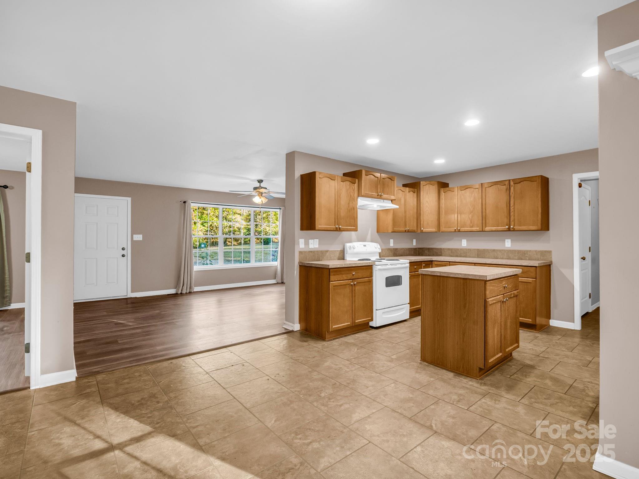 663 Landrum Road Columbus, NC 28722 - Photo 7 of 40 a kitchen with stainless steel appliances granite countertop a stove a sink a microwave a counter top space and cabinets