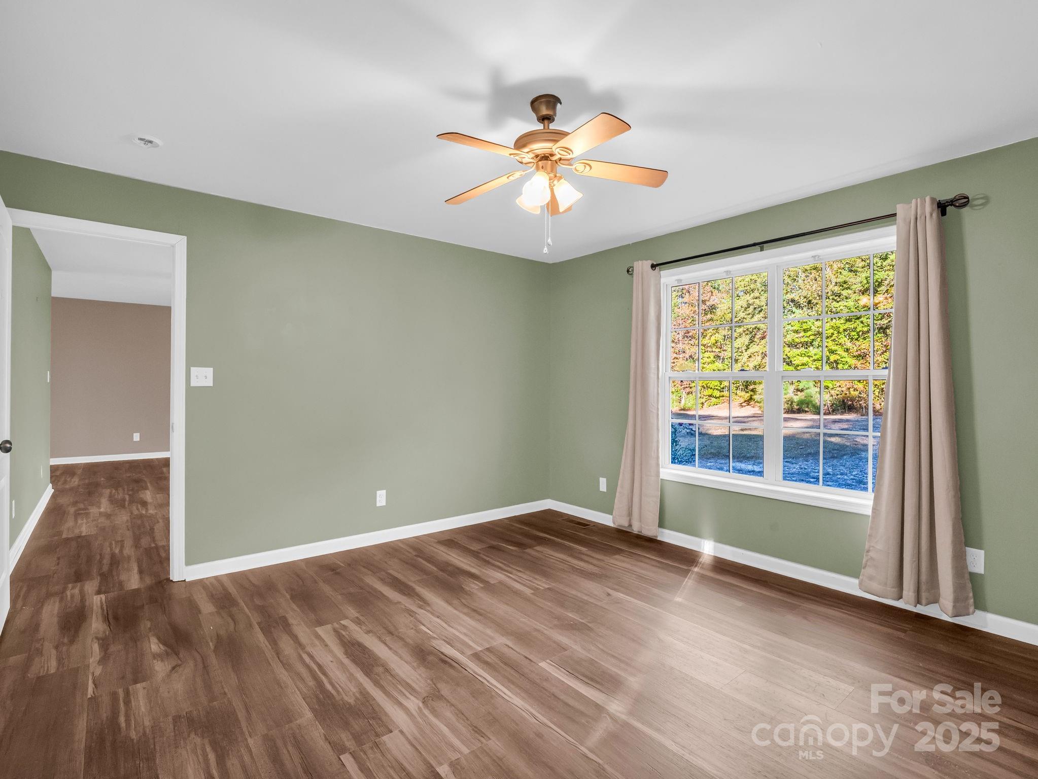663 Landrum Road Columbus, NC 28722 - Photo 8 of 40 wooden floor in an empty room with a window