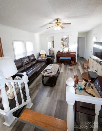 a living room with furniture fireplace and a window