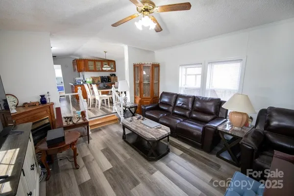 a living room with furniture a wooden floor and a window