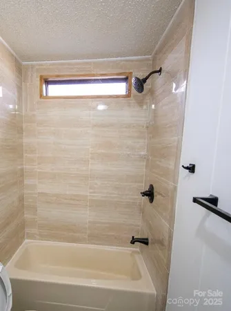 a bathroom with a shower and a bath tub