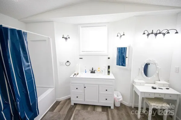 a bathroom with a double vanity sink a mirror and a shower