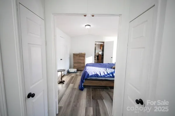 a bedroom with a bed and a white cabinet