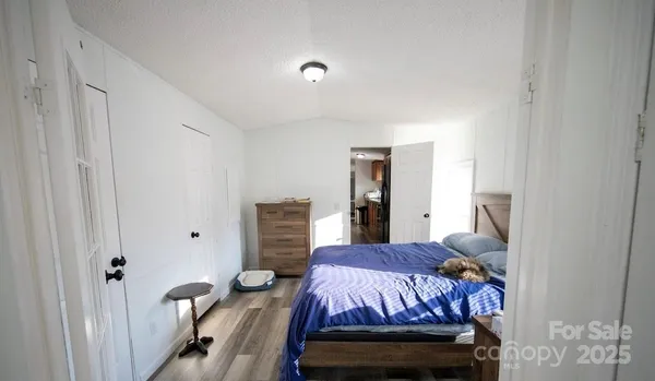 a bedroom with a bed and a refrigerator