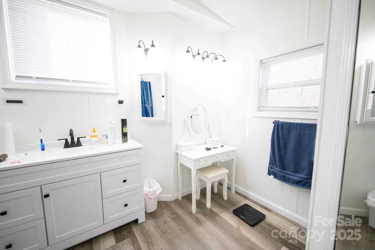 717 Pine Mountain Road Hudson, NC 28638 - Photo 28 of 31 a en suite bathroom with a double vanity sink a mirror and a bathtub