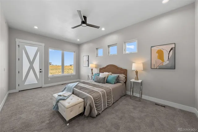 a bedroom with a bed painted wall painting and a window