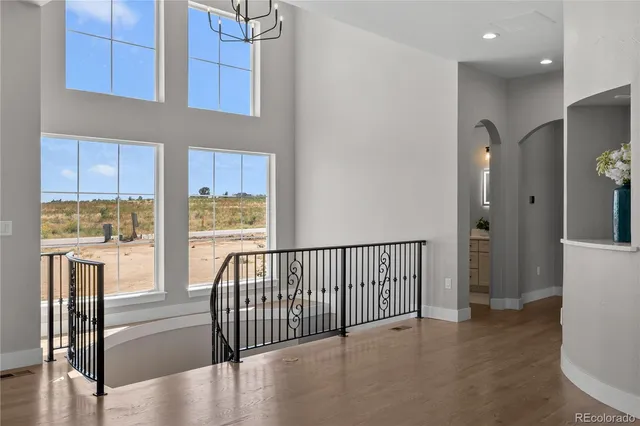 a view of hallway with furniture and a wooden floor