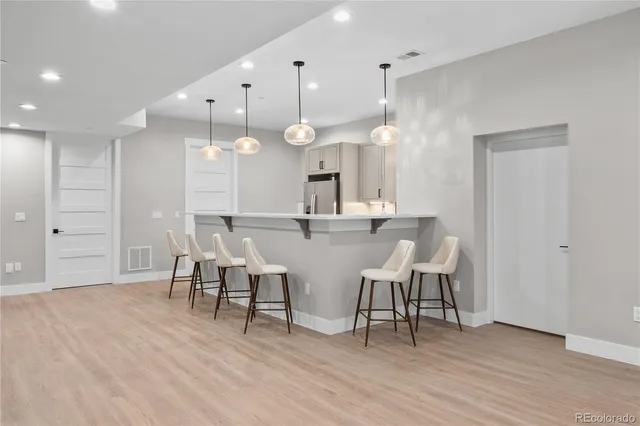 a view of a a dining room with furniture and wooden floor