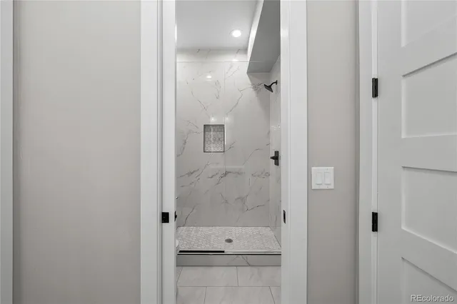 a bathroom with a glass shower door
