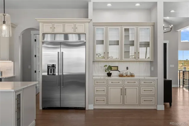 a kitchen with a refrigerator and cabinets