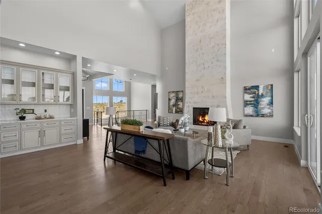 a living room with fireplace furniture and a wooden floor