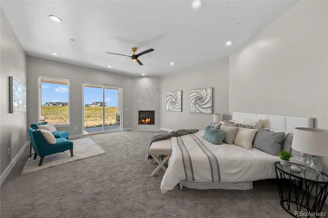 a spacious bedroom with a bed a couch and dresser