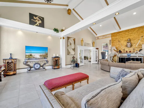 a living room with furniture ceiling fan and a rug