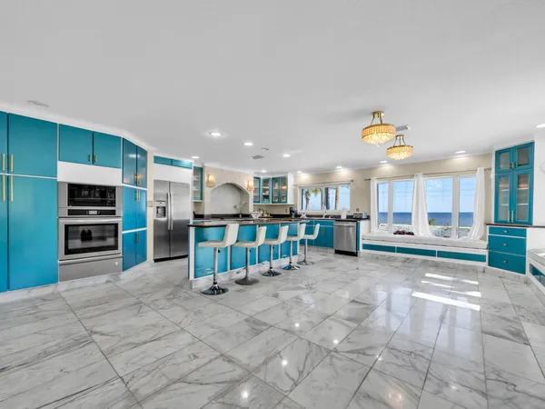 a kitchen with stainless steel appliances granite countertop a sink a stove and a microwave