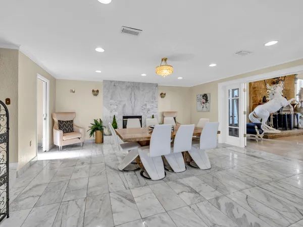 a bedroom with two beds and a chandelier