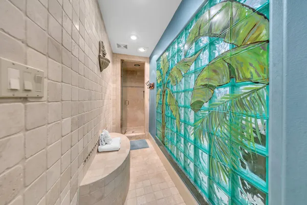 a kitchen with stainless steel appliances granite countertop a refrigerator a sink dishwasher a dining table and chairs with wooden floor