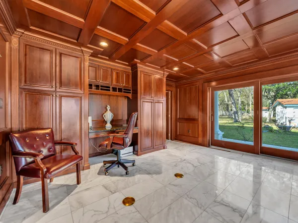 a view of a house with a yard and a tree