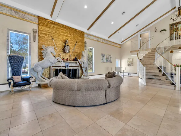 a view of a livingroom with furniture and a large window