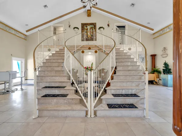 a kitchen with stainless steel appliances granite countertop a refrigerator a sink a stove and a sink