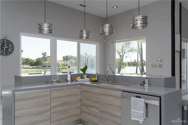 a kitchen with a window and a chandelier