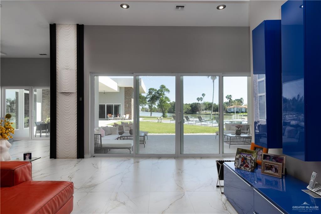 1500 Coffee Port Road Brownsville, TX 78521 - Photo 12 of 42 a view of a living room with furniture and floor to ceiling window