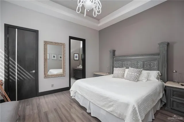 a bedroom with a bed and a chandelier