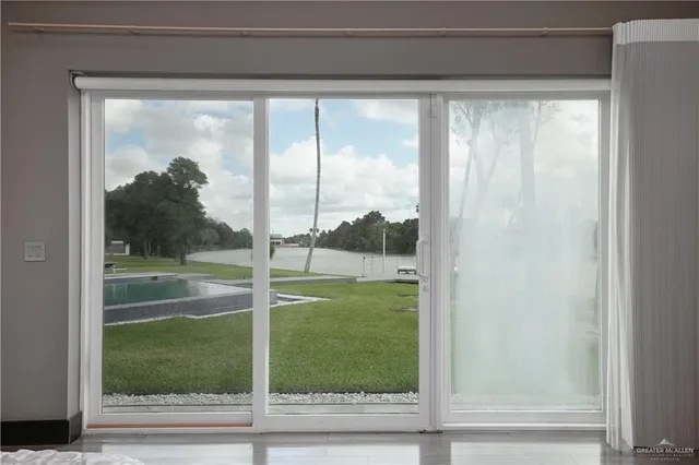 a view of a glass door and a yard from a window