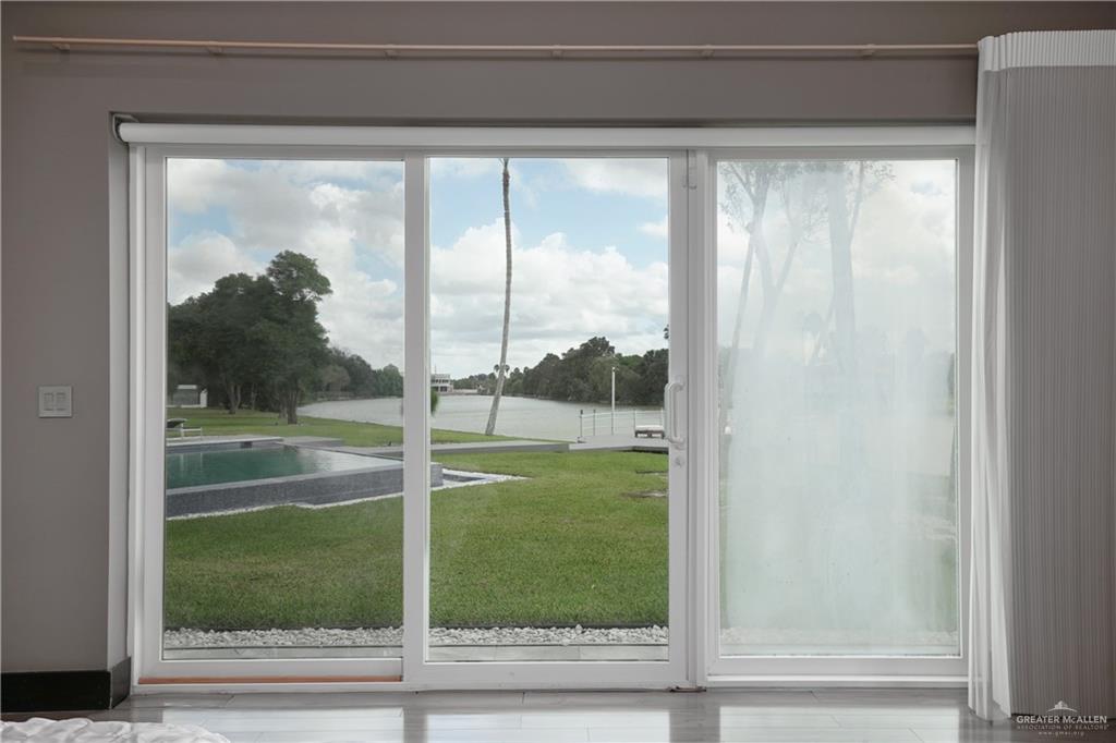 1500 Coffee Port Road Brownsville, TX 78521 - Photo 19 of 42 a view of a glass door and a yard from a window