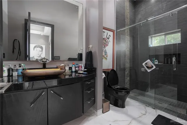 a bathroom with a sink mirror and a shower