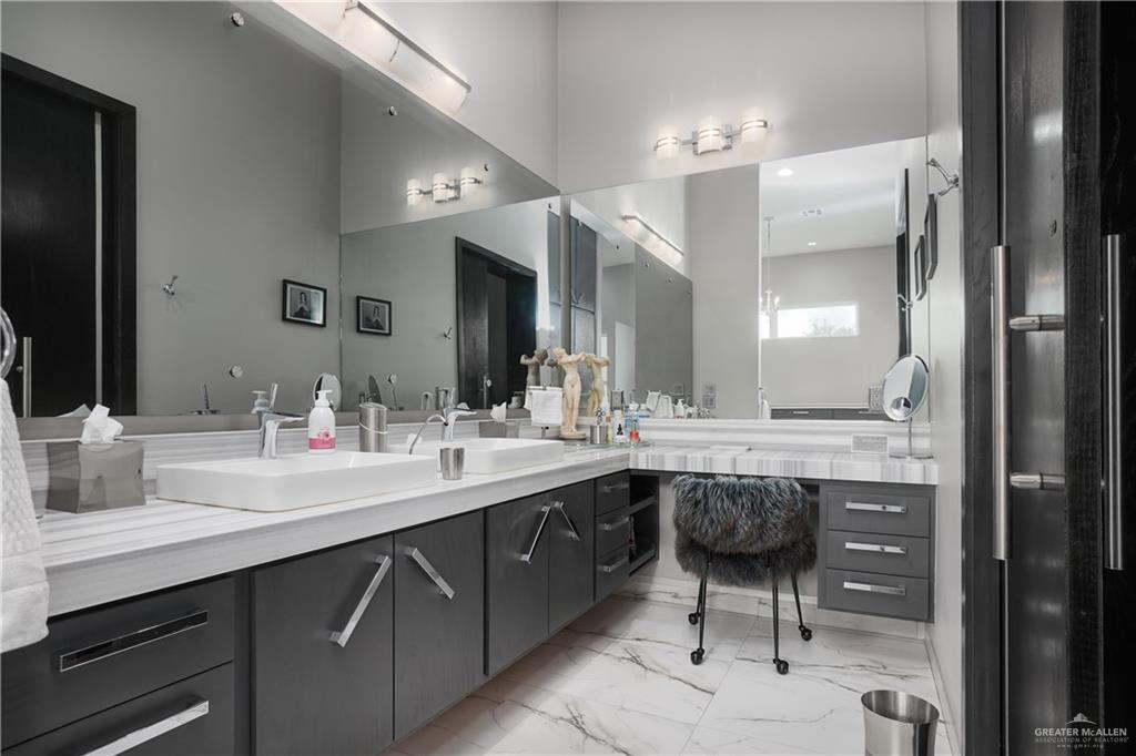 1500 Coffee Port Road Brownsville, TX 78521 - Photo 21 of 42 a bathroom with a double vanity sink and a mirror