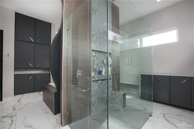 a bathroom with a shower and a sink