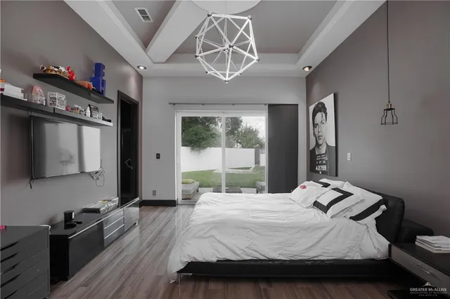 a bedroom with a bed and a large window