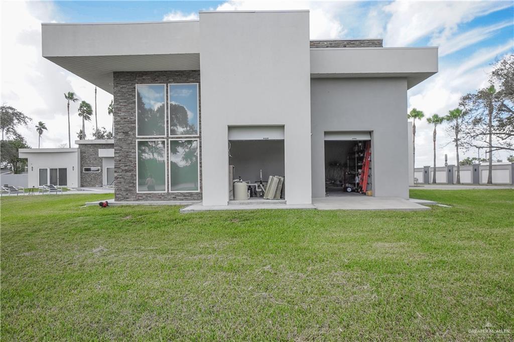 1500 Coffee Port Road Brownsville, TX 78521 - Photo 30 of 42 a view of a house with a yard and a patio