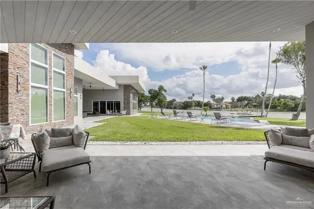 a view of swimming pool is middle in the middle of a yard