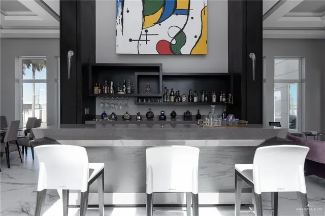 a kitchen with stainless steel appliances granite countertop a dining table and chairs