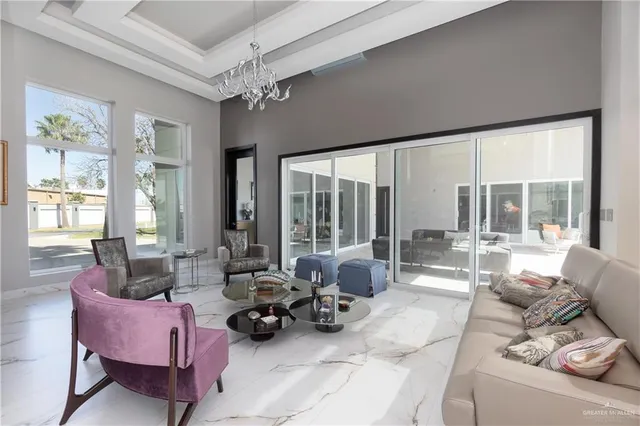 a living room with furniture and large windows