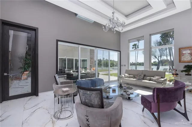 a living room with furniture and a chandelier