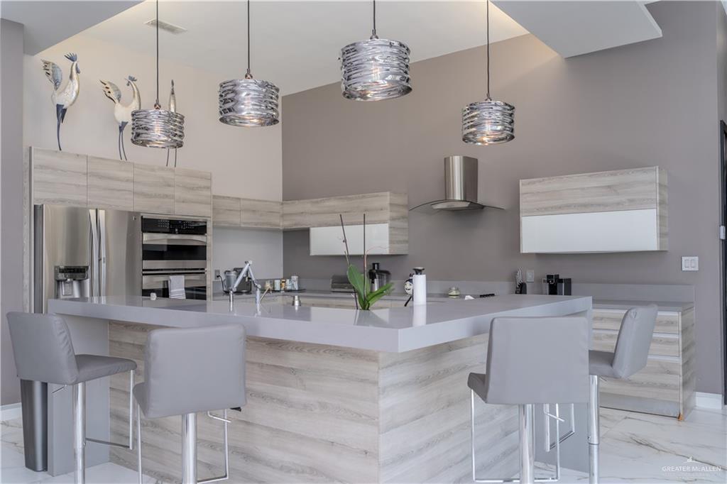 1500 Coffee Port Road Brownsville, TX 78521 - Photo 10 of 42 a kitchen with stainless steel appliances granite countertop a sink and a chandelier