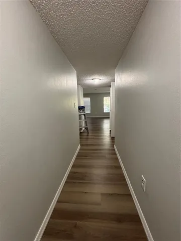 a view of entryway and hall with wooden floor