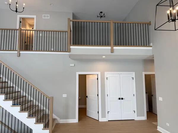 a view of staircase with railing and a window