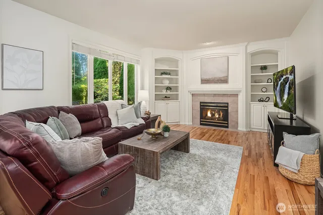 a living room with furniture fireplace and window