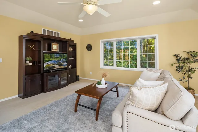 a living room with furniture a fireplace and a window