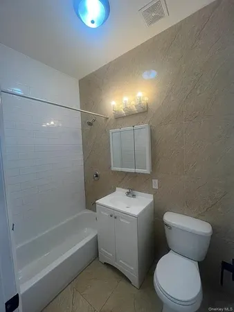 a bathroom with a toilet sink and shower