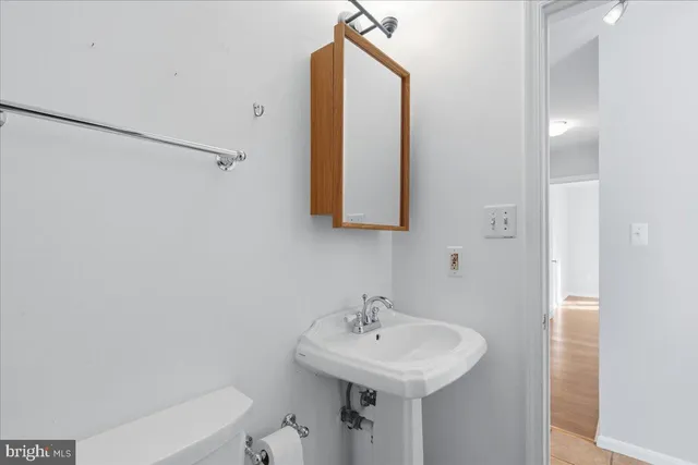 a bathroom with a sink a toilet and mirror