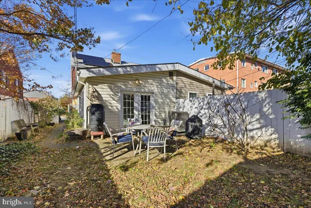 a view of a chairs and table in the backyard