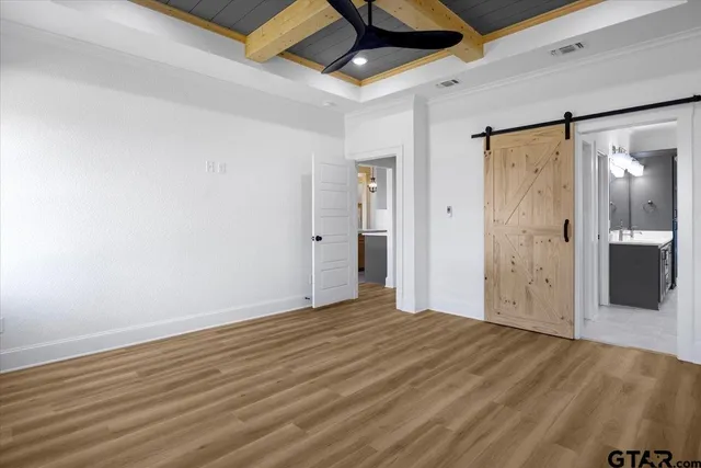 a view of a room with wooden floor